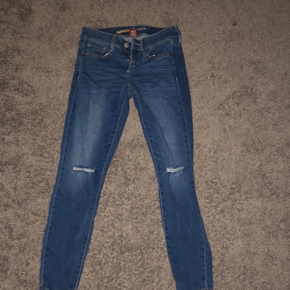 Ripped at the knee blue jeans